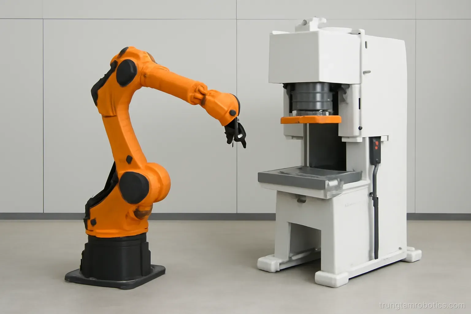 Cánh tay robot công nghiệp đặt cạnh một máy chuyên dụng trong xưởng cơ khí